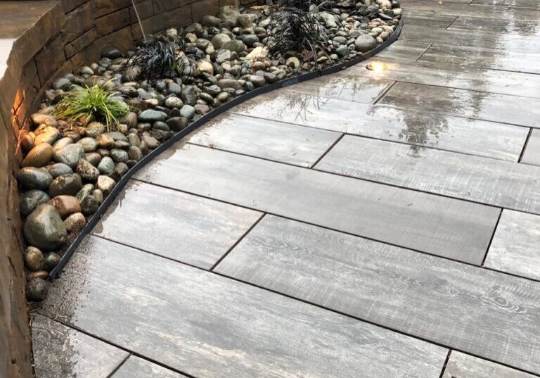 Hardscaping paver patio with a water feature wall